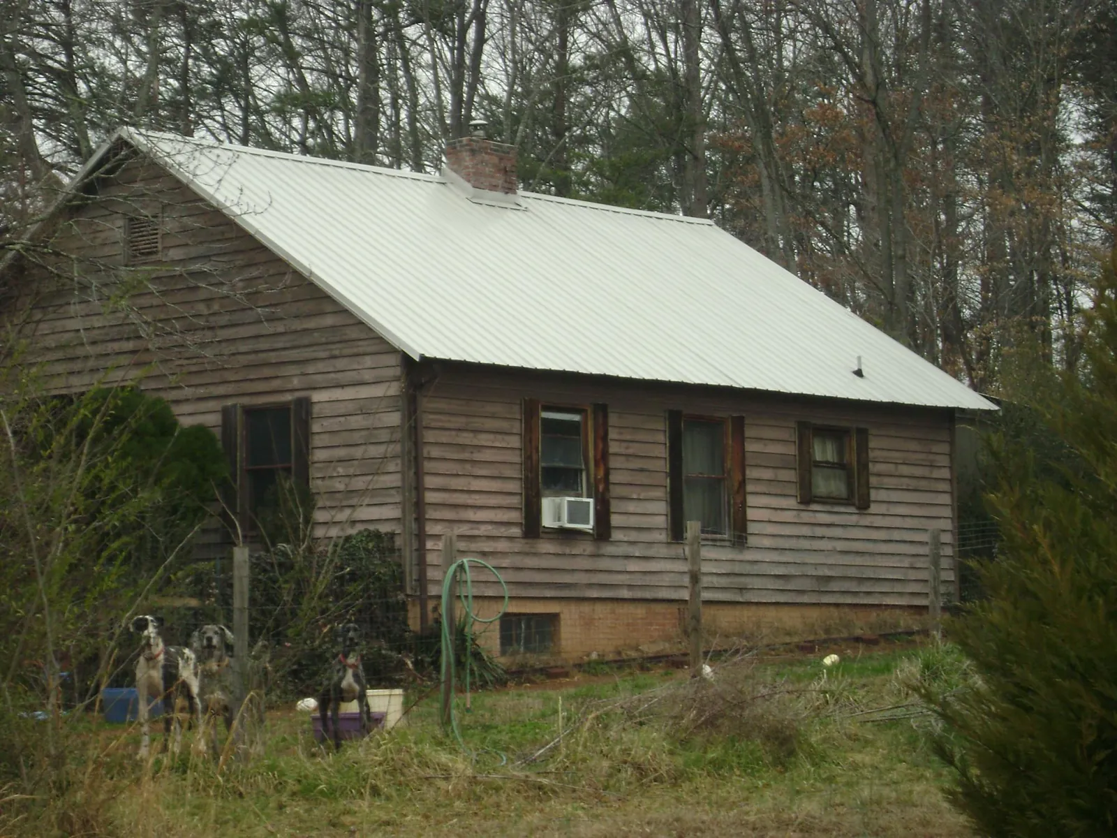 White metal roof on an old wood sided farmhouse, from a Metal Roof Installation job in Dyer